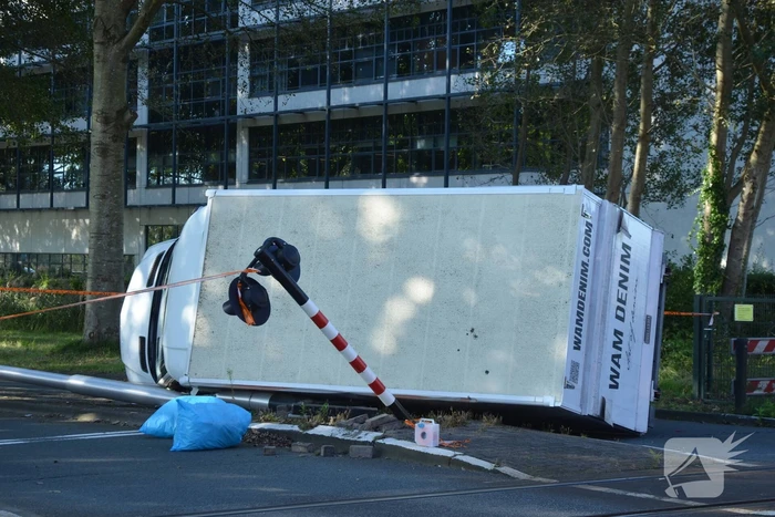 Vrachtwagen kantelt in bocht op overweg