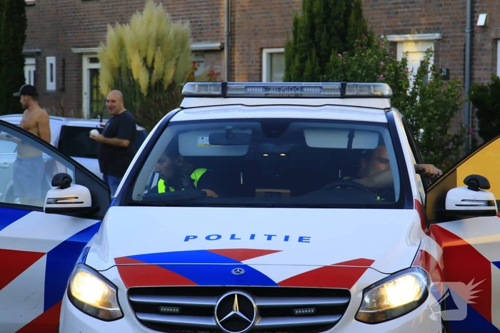 Brandweer blust brandende prullenbak in schuur