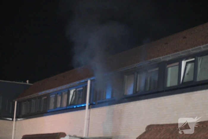 Rookontwikkeling uit woning, persoon naar ziekenhuis