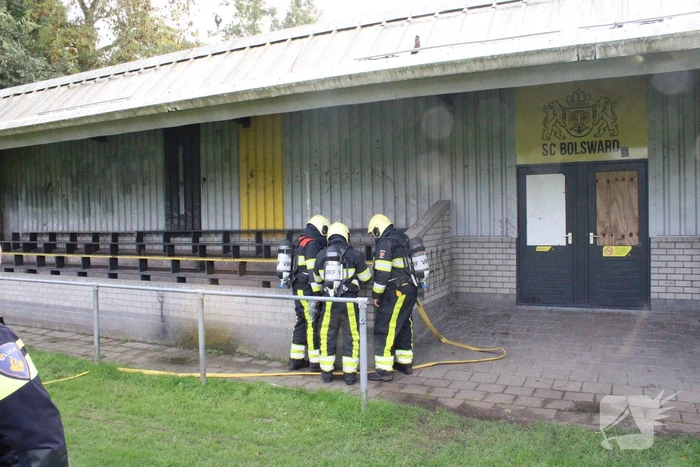 Brandweer blust brand onder voetbaltribune