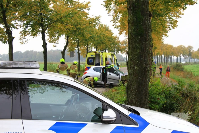 Bestuurder bekneld bij botsing tegen boom