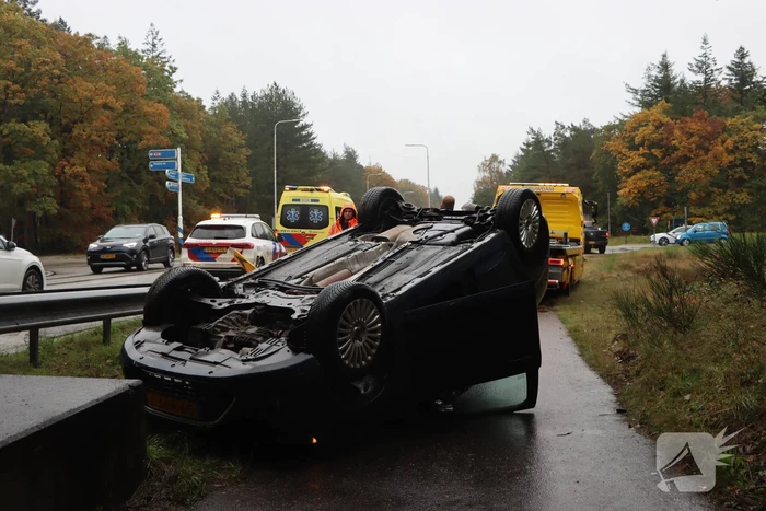 Auto vliegt over vangrail en belandt op kop