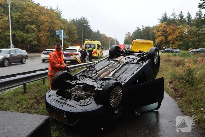 Auto vliegt over vangrail en belandt op kop
