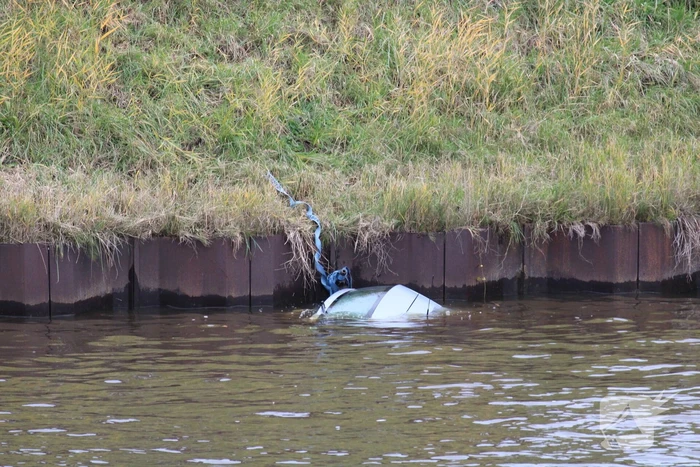 Personenauto rolt kanaal in