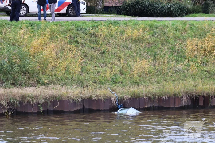 Personenauto rolt kanaal in