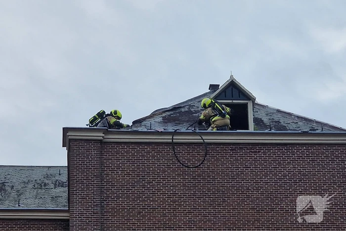 Brandweer blust brand op dak van Kapel