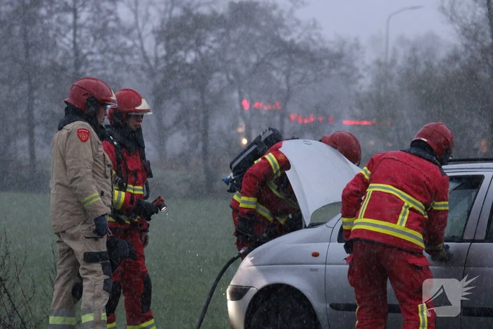 Brandweer blust brandend voertuig