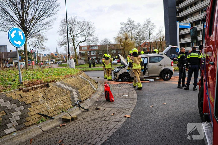 Bestuurder knalt tegen rotonde en belandt op zijkant