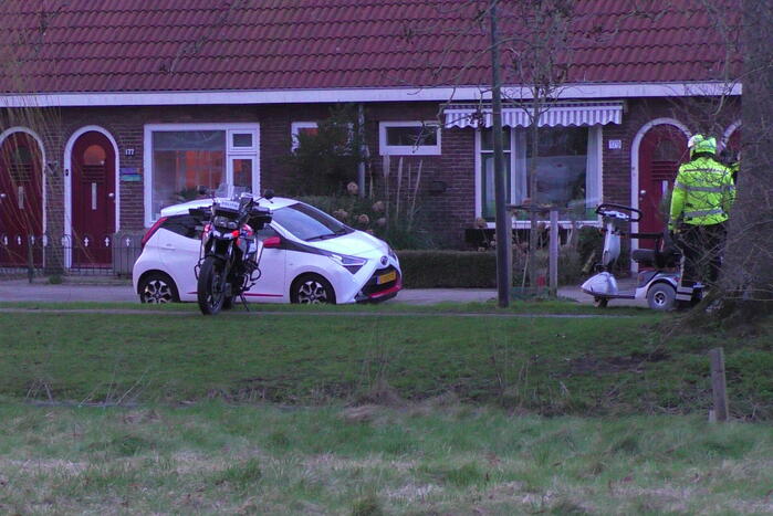 Persoon met scootmobiel te water