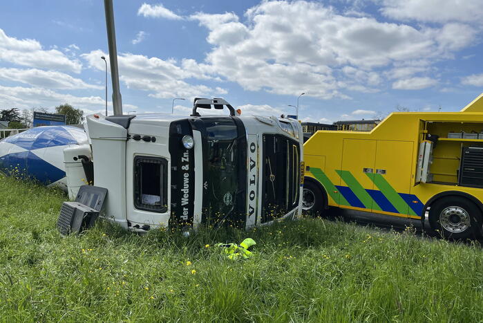 Vrachtwagen met betonmixer oplegger gekanteld