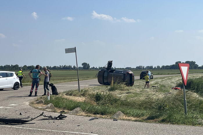 Auto op zijn kant bij botsing