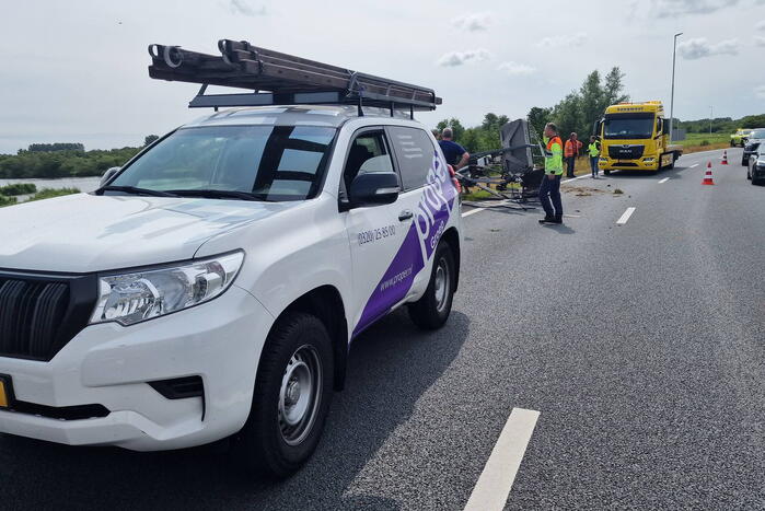 Auto met hoogwerker botst op vangrail