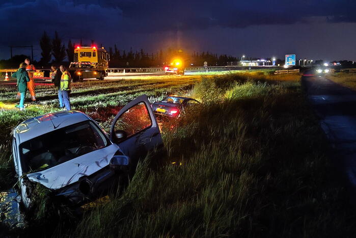 Busje en auto belanden in sloot