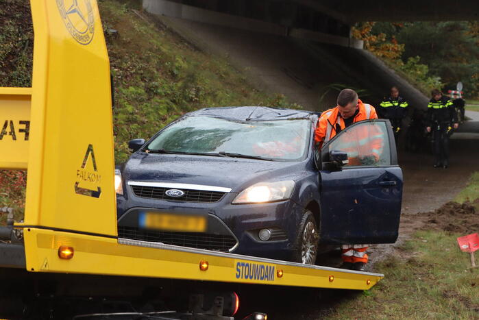 Auto vliegt over vangrail en belandt op kop