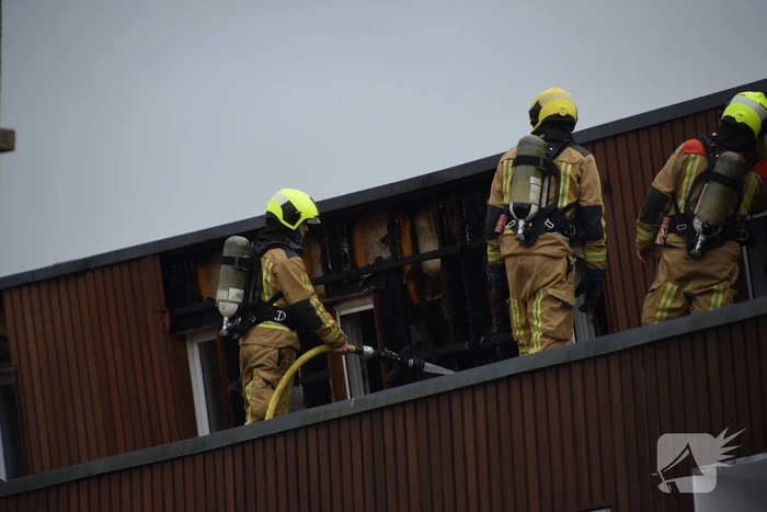 Brandweer blust brandende dakbedekking