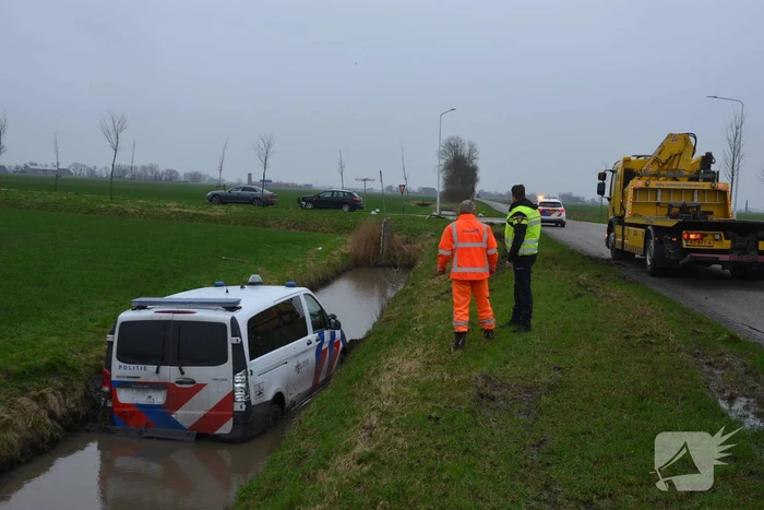 Politiebus te water na aanrijding met auto