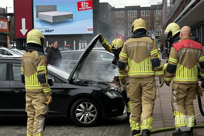 Rook onder de motorkap van de auto