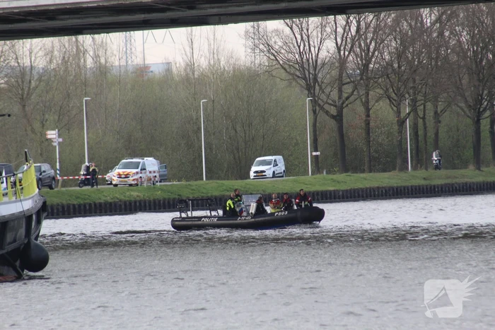 Persoon op bogen van brug, vele hulpdiensten aanwezig