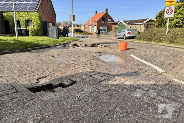 Wegdek verzakt door leidingbreuk