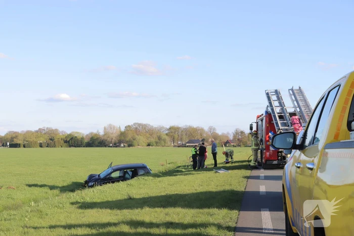 Automobilist raakt van de weg en blijft boven sloot hangen