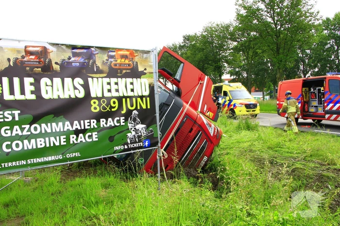 Vrachtwagen op zijn kant in sloot