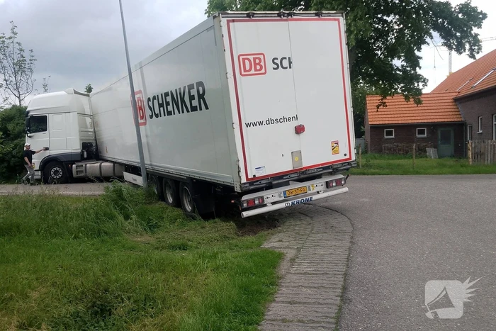 Vrachtwagenchauffeur neemt bocht tekort en rijdt zich vast
