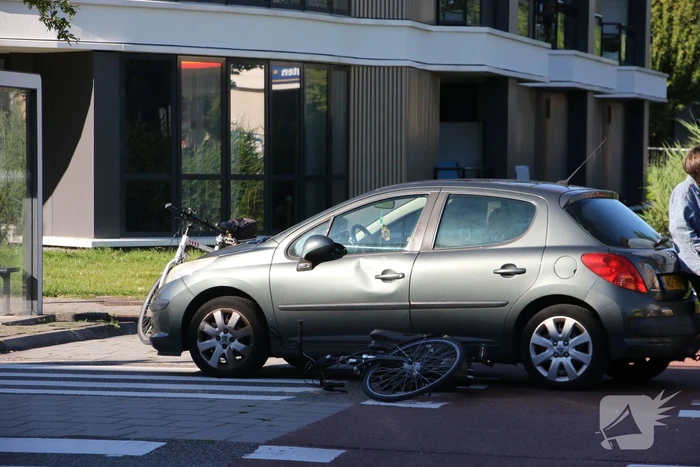 Fietser klapt op zijkant van auto tijdens het oversteken op rotonde