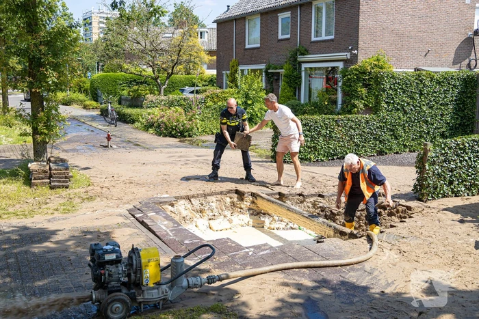 Straat blank door een gesprongen waterleiding