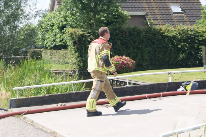 Container in brand tegen woning