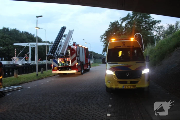 Persoon onwel op peiler van brug, brandweer haalt hem eraf
