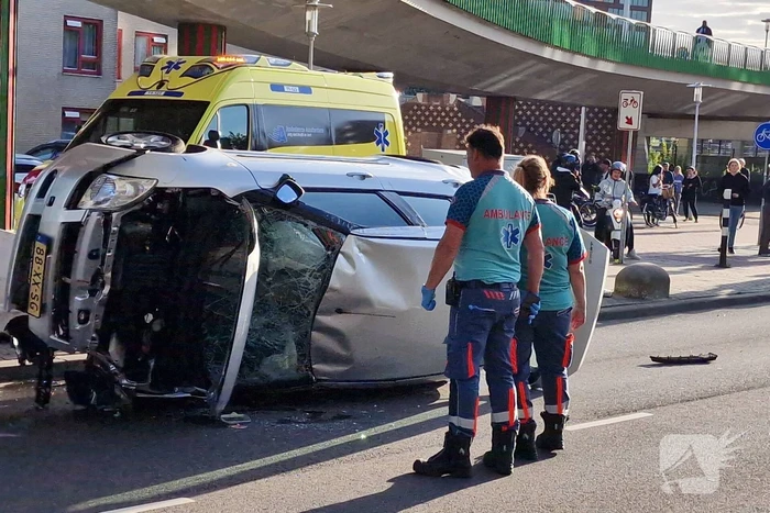 Auto belandt op zijkant, vrouw gewond
