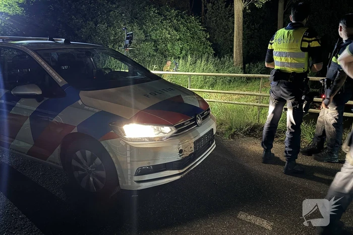 Auto te water na politieachtervolging, twee personen aangehouden