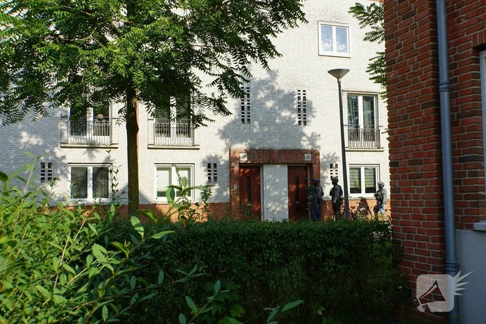 Agenten in kogelwerende vesten en Dienst Speciale Interventies bij inval in woning