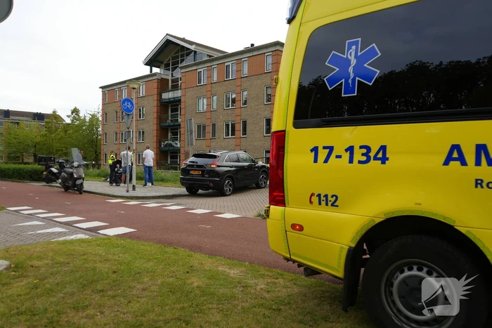 Scooterrijder komt ten val, ambulancepersoneel biedt hulp
