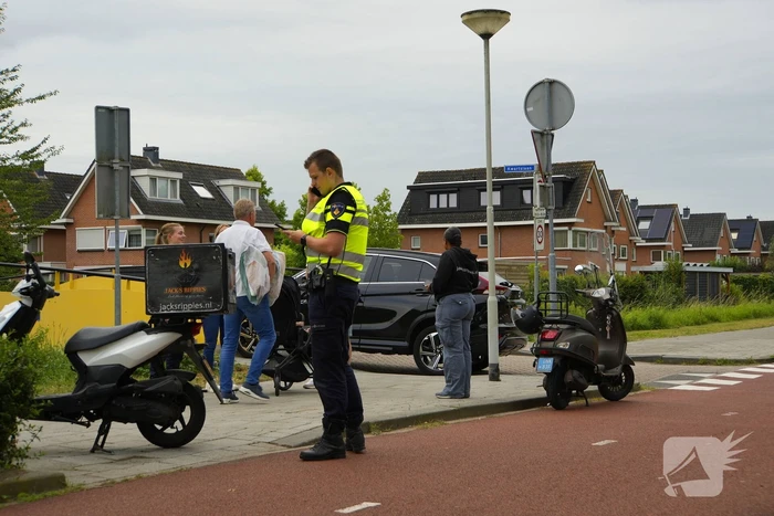 Scooterrijder komt ten val, ambulancepersoneel biedt hulp