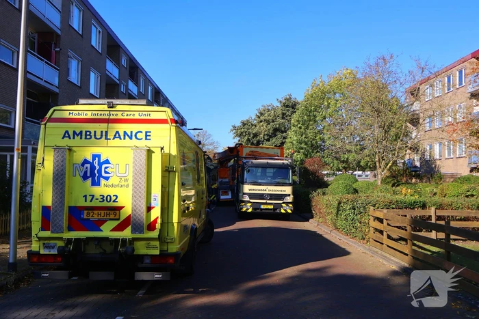 Persoon door hijskraan uit flatwoning getakeld