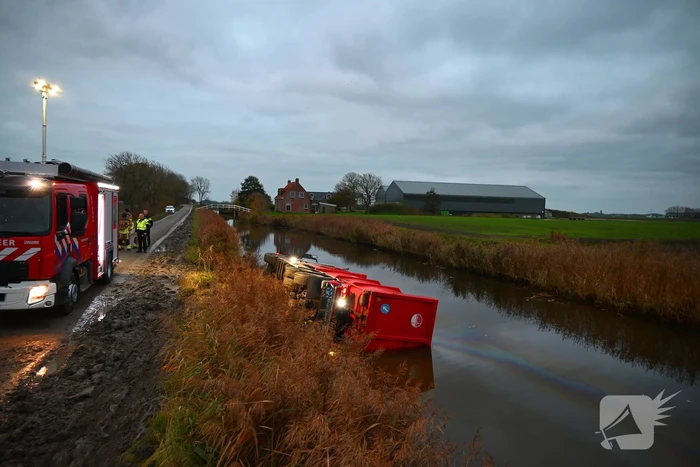 Vrachtwagen op zijn kant in de sloot