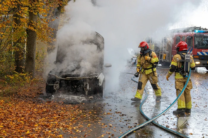 Brandweer blust brand in personenauto