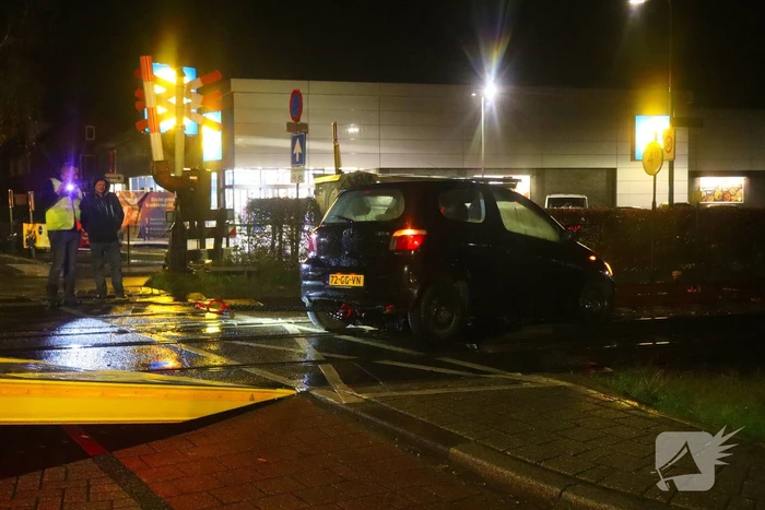 Auto belandt gedeeltelijk op spoor bij overweg