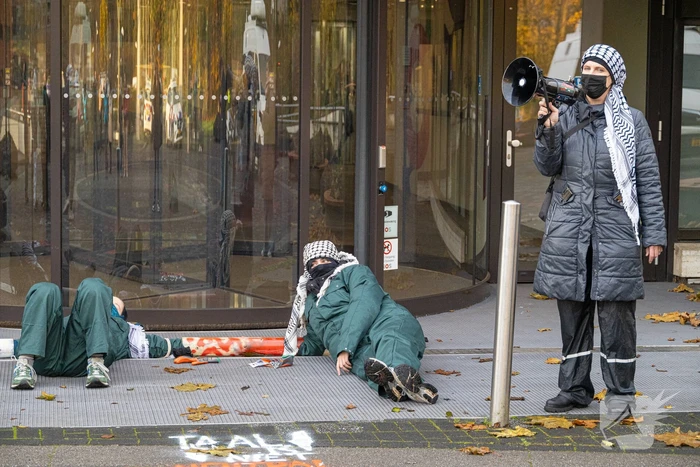 Demonstranten klimmen op het dak van NOS-gebouw