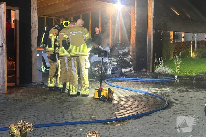 Auto vliegt in brand onder carport