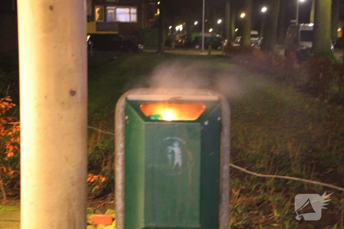 Brandweer blust brandende prullenbak