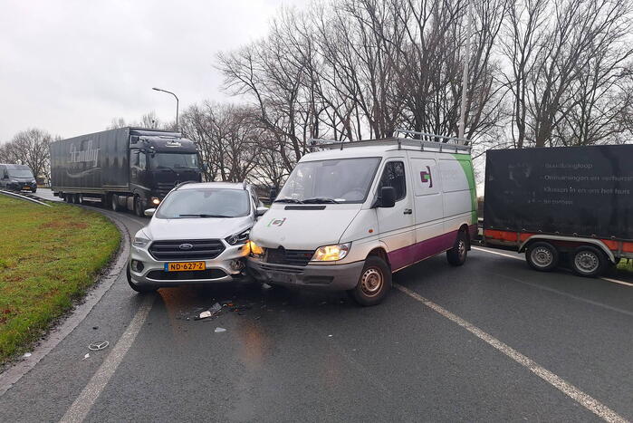 Bestelbus met aanhanger klapt op tegenligger
