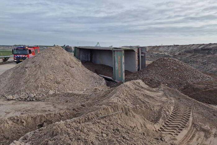 Vrachtwagen kantelt op bouwplaats