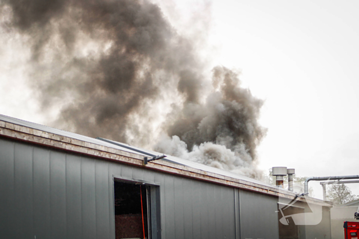 Zwarte rookwolken bij brand in opslag
