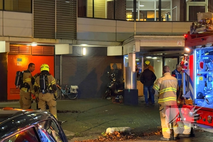Scooter vat vlam in hal van flat