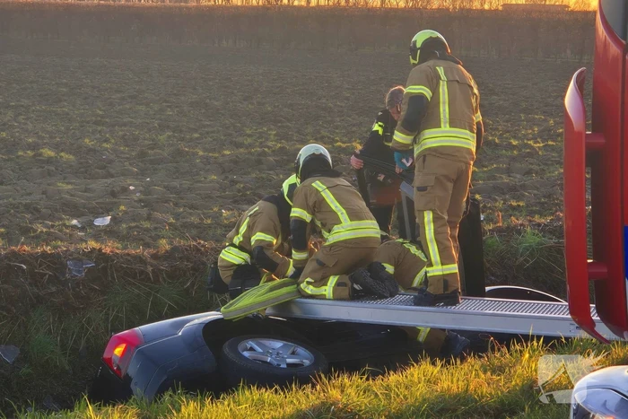 Voertuig belandt op zijkant in water na ongeval