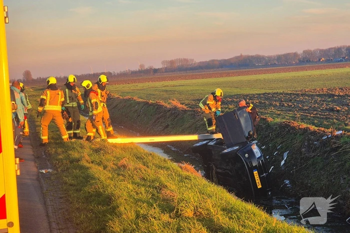 Voertuig belandt op zijkant in water na ongeval