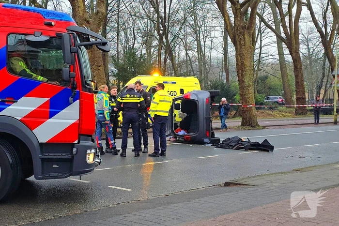 Auto belandt op zijn kant na botsing tegen boom