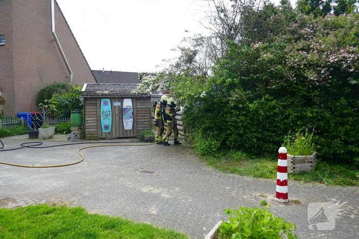 Schade aan poort en schutting door brand